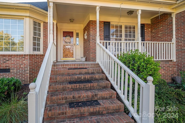 entrance to property featuring a porch