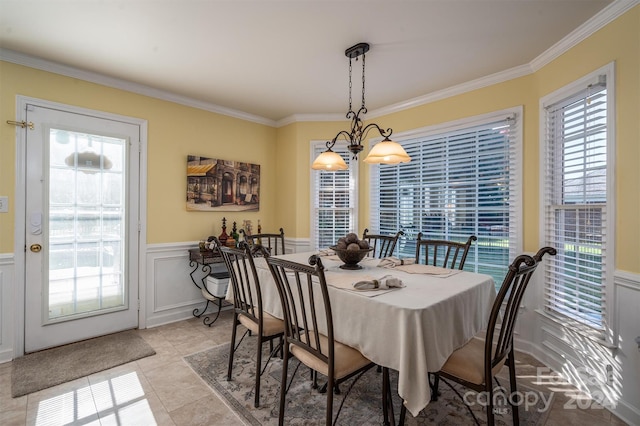 tiled dining room featuring crown molding and a notable chandelier