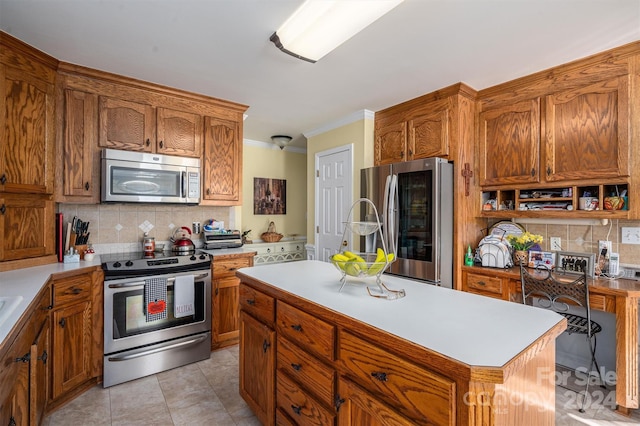 kitchen with backsplash, appliances with stainless steel finishes, a center island, and ornamental molding