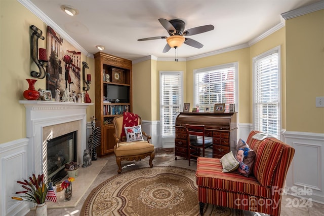 sitting room featuring ornamental molding, ceiling fan, a fireplace, and plenty of natural light