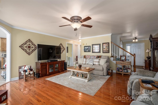 living room with ceiling fan, wood-type flooring, and ornamental molding