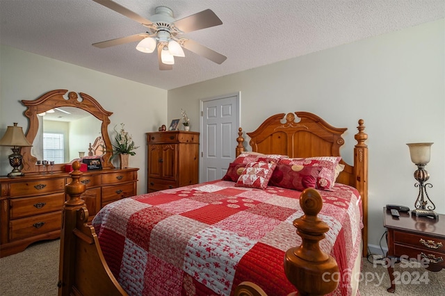 bedroom with a textured ceiling, carpet, and ceiling fan