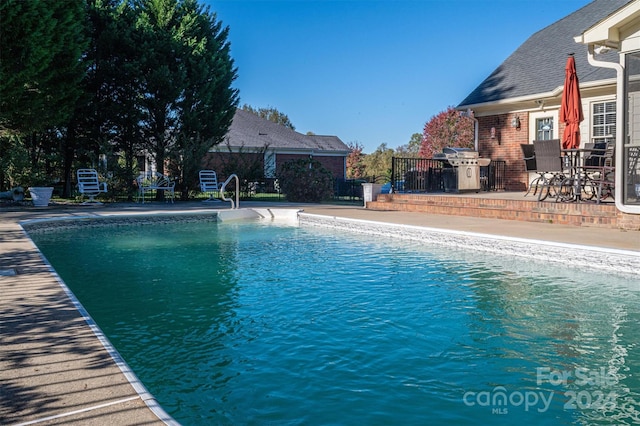 view of swimming pool featuring a patio area