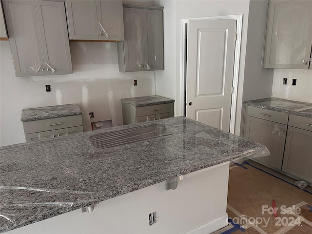 4057 Port Richmond Ave Unit 13, Gastonia, NC 28056 - kitchen with dark stone counters, gray cabinets, and a kitchen breakfast bar