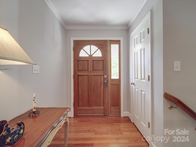 entrance foyer with crown molding and light hardwood / wood-style floors