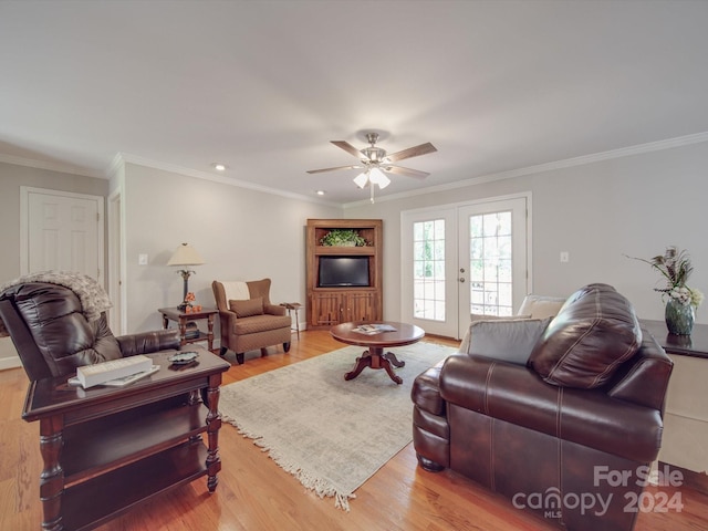 living room with crown molding, ceiling fan, light wood-type flooring, and french doors