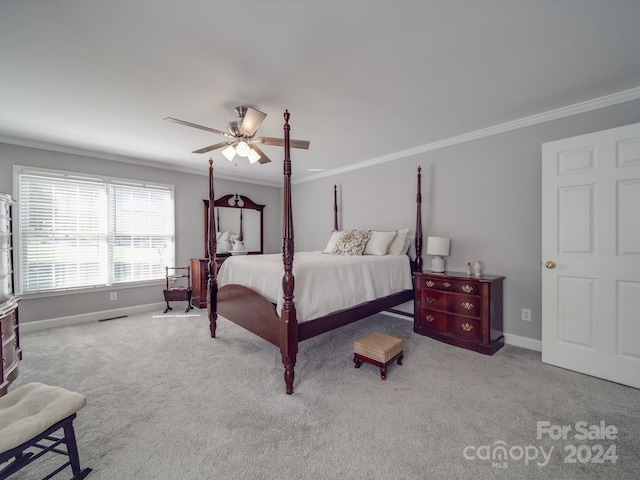 carpeted bedroom featuring ceiling fan and crown molding