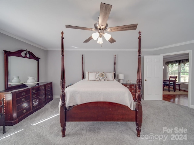 carpeted bedroom featuring crown molding and ceiling fan