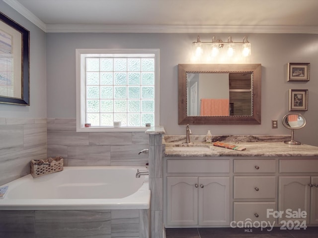 bathroom featuring vanity, tiled bath, and crown molding