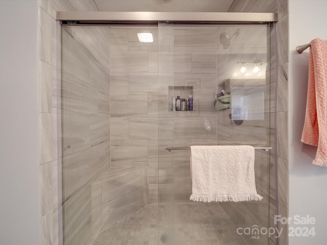 bathroom featuring a shower with shower door