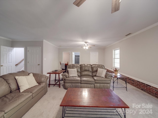 living room with crown molding, light colored carpet, and ceiling fan