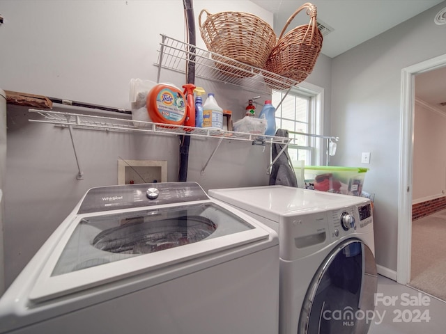 laundry area with carpet flooring and separate washer and dryer