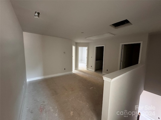 unfurnished room with concrete flooring