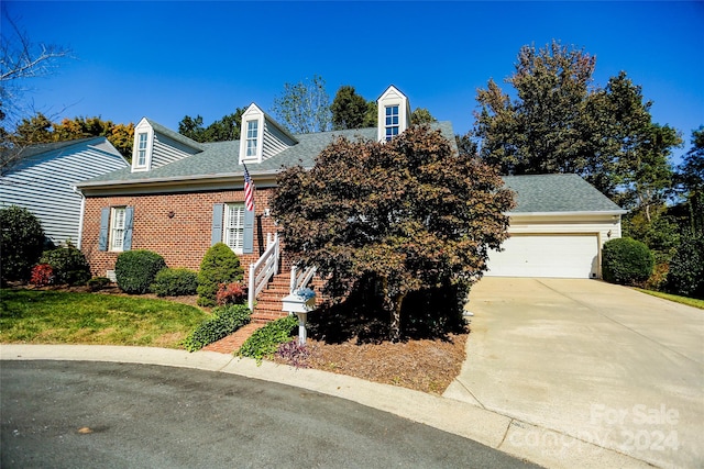 new england style home with a garage