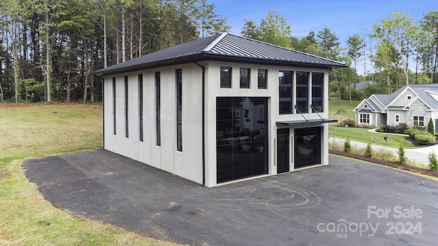 view of outbuilding featuring a yard