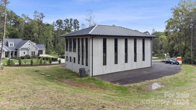 view of property exterior with a lawn