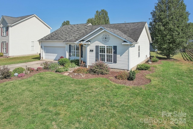 view of front of home with a front yard and a garage