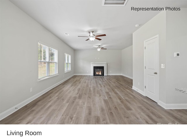 unfurnished living room with light wood-type flooring and ceiling fan