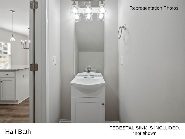 209 Lake George Dr, Shelby, NC 28152 - bathroom featuring vanity, wood finished floors, and a notable chandelier