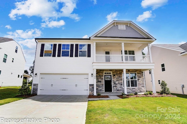 view of front of property featuring a balcony, a front lawn, and a garage