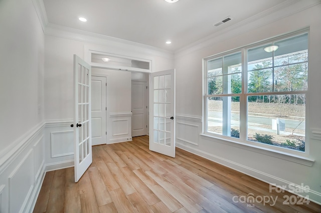 unfurnished bedroom with a closet, light hardwood / wood-style floors, ornamental molding, and french doors