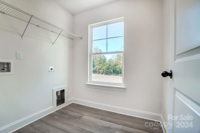 laundry room with electric dryer hookup, a wealth of natural light, hookup for a washing machine, and hardwood / wood-style flooring