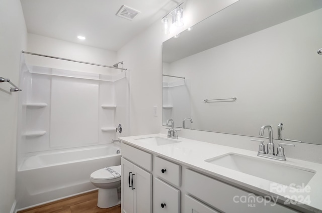 full bathroom with shower / tub combination, toilet, vanity, and hardwood / wood-style flooring