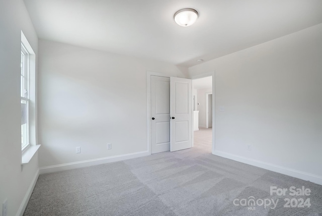 empty room featuring light colored carpet