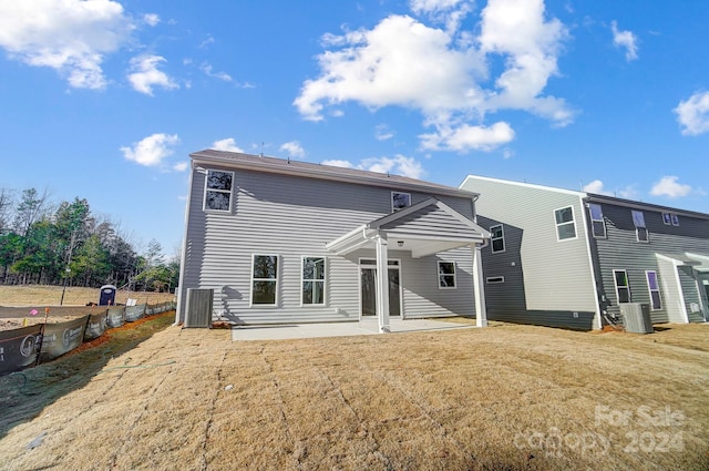 back of property featuring a lawn and a patio area