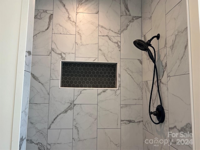 room details featuring a tile shower