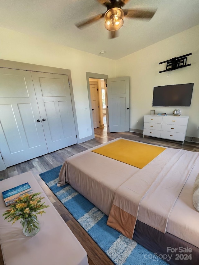 bedroom featuring a closet, hardwood / wood-style floors, and ceiling fan