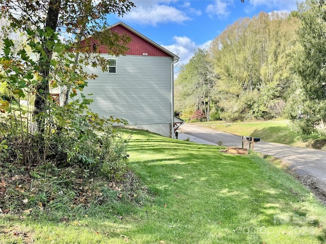 view of side of home featuring a lawn