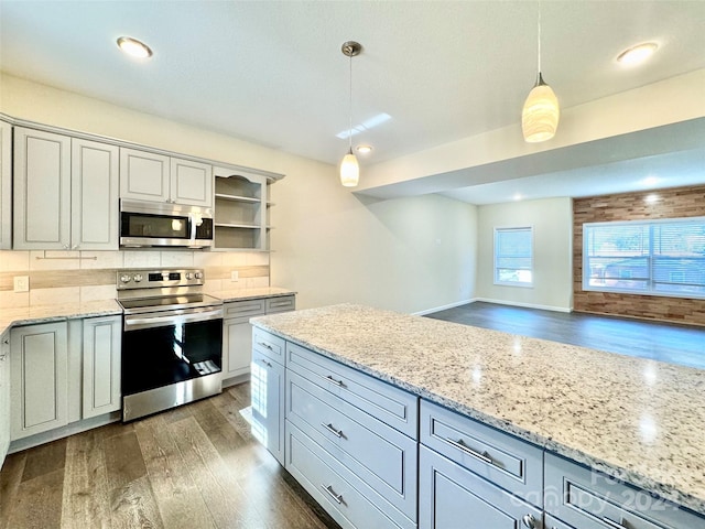 kitchen with gray cabinetry, dark wood-type flooring, decorative light fixtures, and stainless steel appliances