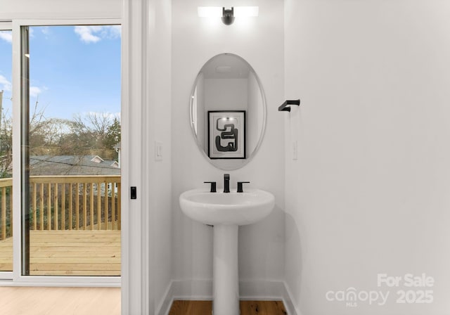 bathroom with sink, a wealth of natural light, and hardwood / wood-style floors