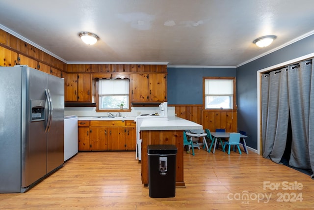 kitchen featuring a healthy amount of sunlight, stainless steel fridge with ice dispenser, and light wood-type flooring