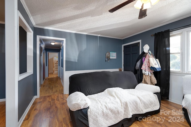 interior space featuring ornamental molding, a textured ceiling, dark hardwood / wood-style floors, and ceiling fan