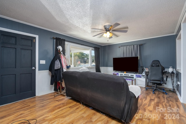 living room featuring hardwood / wood-style floors, crown molding, a textured ceiling, and ceiling fan