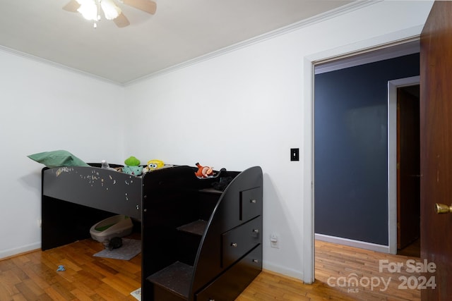 bedroom featuring ornamental molding, wood-type flooring, and ceiling fan