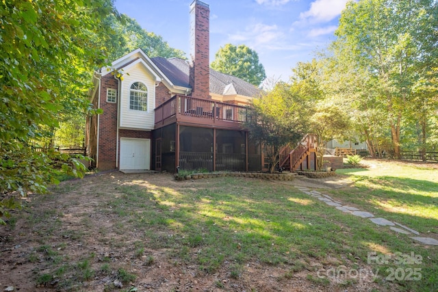 back of house with a wooden deck, a garage, a yard, and a sunroom