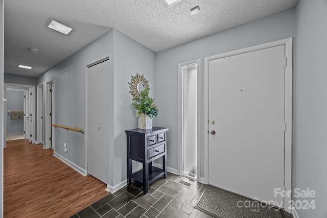 entryway featuring dark hardwood / wood-style floors and a textured ceiling