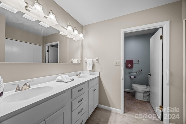 bathroom with vanity, toilet, and tile patterned floors