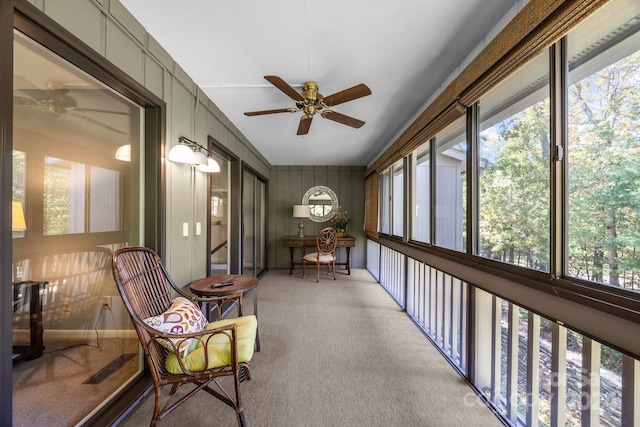 sunroom with a healthy amount of sunlight and ceiling fan