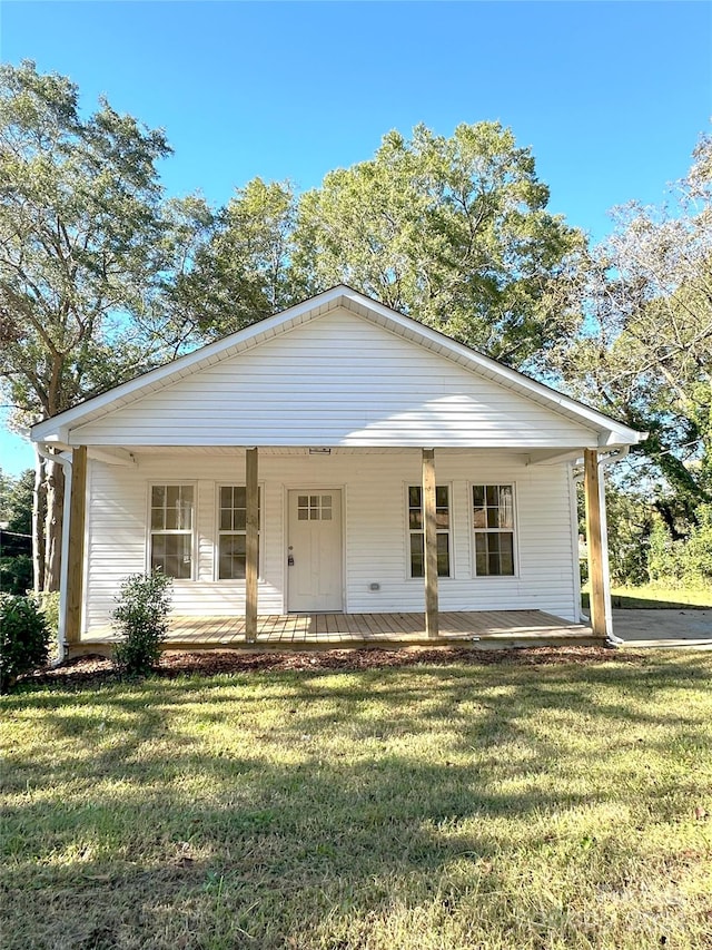 view of front of house with a front yard and covered porch