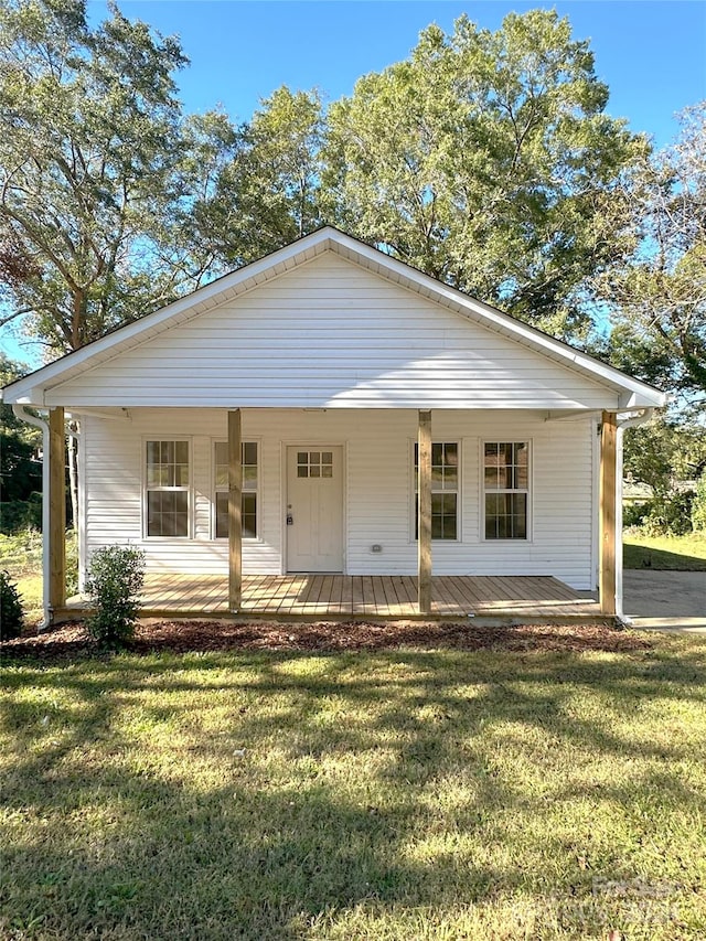 view of front of house with a porch and a front lawn