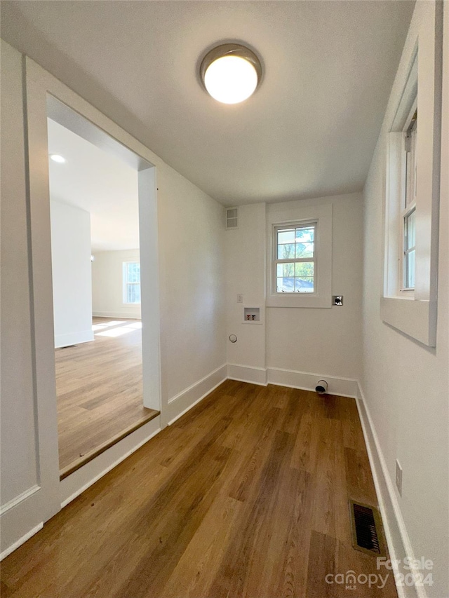 washroom featuring hookup for a washing machine, electric dryer hookup, and hardwood / wood-style floors