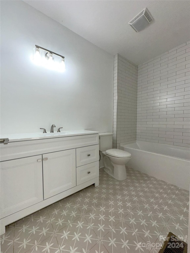 full bathroom featuring vanity, toilet, and tiled shower / bath combo