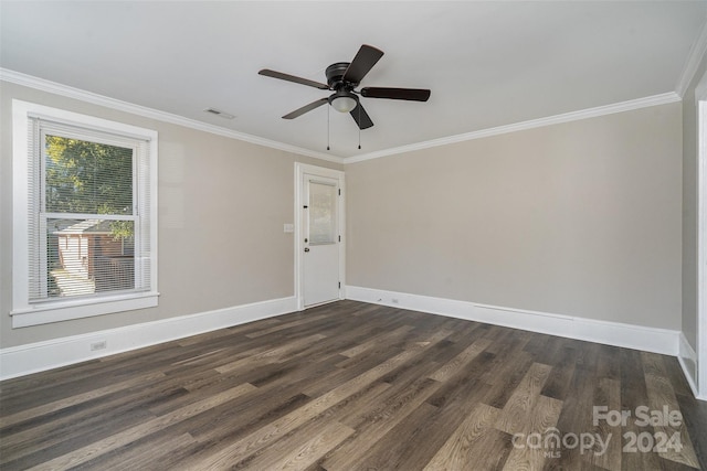 spare room featuring ornamental molding and dark hardwood / wood-style flooring