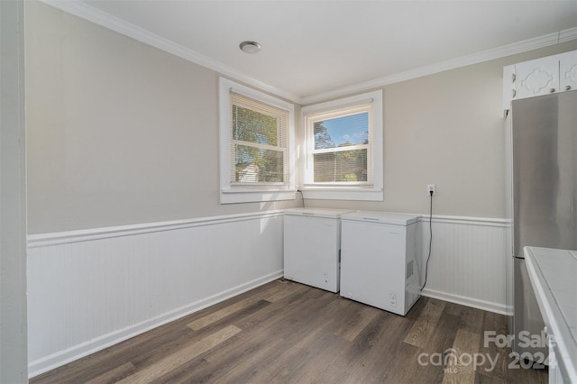 clothes washing area featuring washing machine and clothes dryer, crown molding, and dark hardwood / wood-style floors