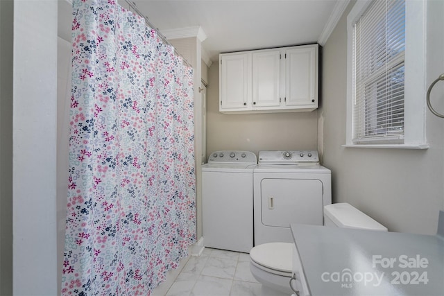 washroom featuring ornamental molding and washing machine and clothes dryer