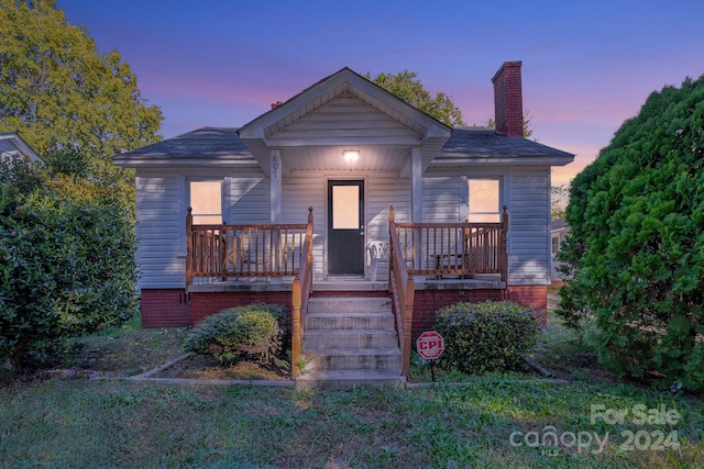 bungalow-style house with a lawn